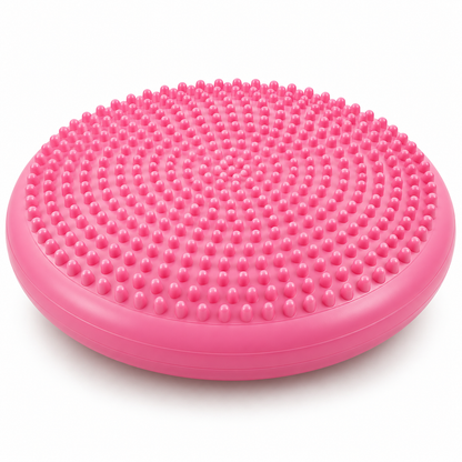 Pink textured circular balance exercise pad on white